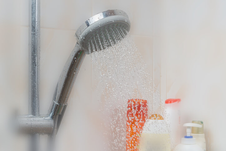 GettyImages-1032231788 hot water coming out of shower head