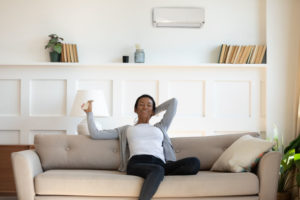 woman operating a ductless unit in her home