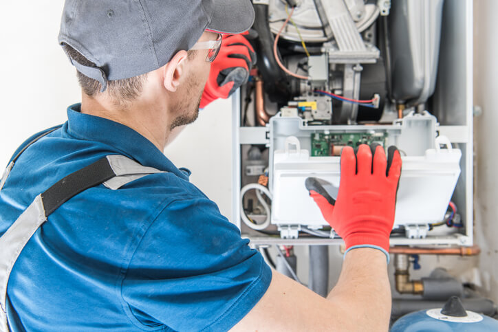 technician repairing a heating system